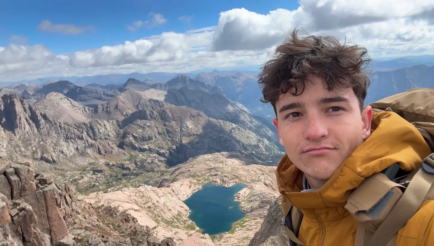 Kempton Burton backpacking above an alpine lake in Colorado
